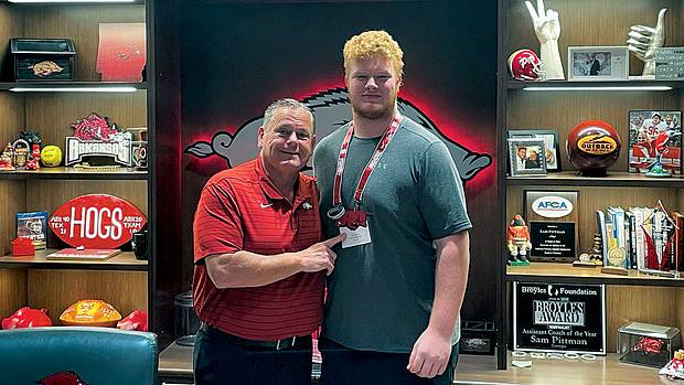 Wakeland High School offensive lineman Connor Stroh hangs out with Arkansas coach Sam Pittman during an April visit to Fayetteville. It was Stroh's second time to make the drive from Frisco, Texas in the span of just a few months.