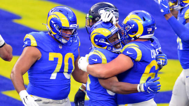 Nov 15, 2020; Inglewood, California, USA; Los Angeles Rams running back Malcolm Brown (34) celebrates with offensive guard Austin Corbett (63) and offensive guard Joe Noteboom (70) his touchdown scored against the Seattle Seahawks during the second half at SoFi Stadium.