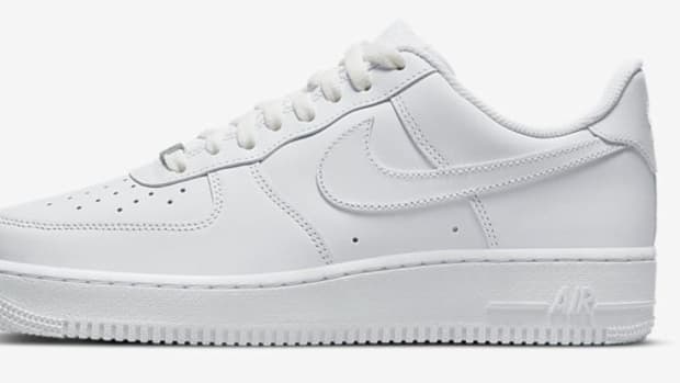 Side view of a white Nike Air Force 1 Low sneaker.