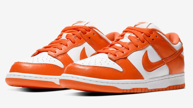 Orange and white Nike Dunk shoes.