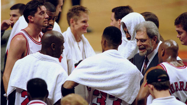 Chicago Bulls coach Phil Jackson, right, with team (clockwise from Phil) Scott Burrell (24), Scottie Pippen (33), Michael Jordan (23), Toni Kukoc (7), Dickey Simpkins (8), Steve Kerr (25) and Dennis Rodman (91)