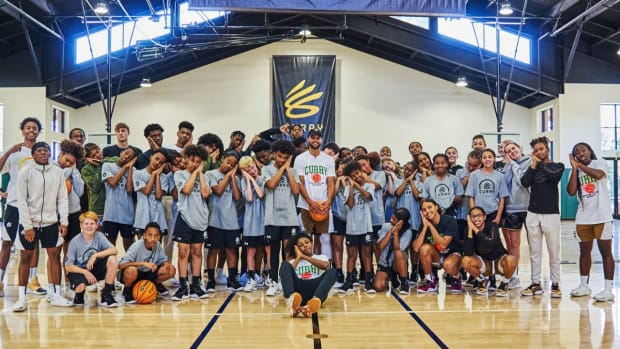 Stephen Curry poses with kids at his basketball camp.