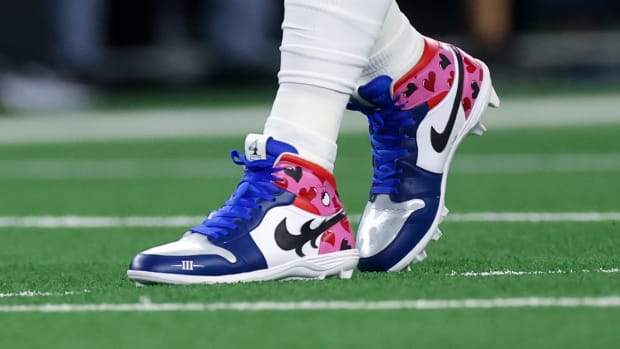 View of blue and pink Air Jordan cleats.