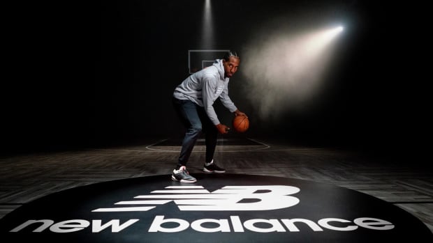 Kawhi Leonard dribbles basketball in photo shoot.