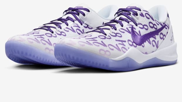 Side view of Kobe Bryant's white and purple Nike sneakers.