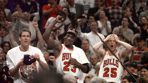 Jun 13, 1997; Chicago, IL, USA; Chicago Bulls players Judd Buechler, left, Michael Jordan, middle, and Steve Kerr celebrate after winning the NBA championship after defeating the Utah Jazz in the 1997 NBA Finals at the United Center.