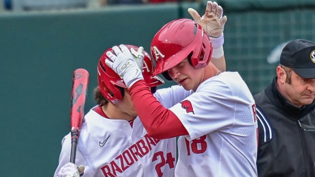 Razorbacks Parker Rowland and Reese Robinette celebrate during sixth-inning rally.