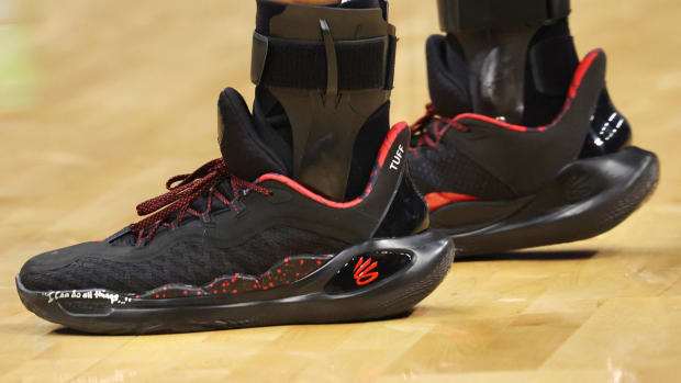 Golden State Warriors guard Stephen Curry's black and red Under Armour sneakers.
