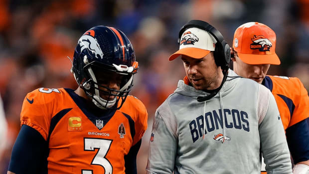 Jan 8, 2023; Denver, Colorado, USA; Denver Broncos quarterback Russell Wilson (3) talks with quarterbacks coach Klint Kubiak in the fourth quarter against the Los Angeles Chargers at Empower Field at Mile High.