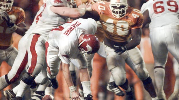Razorbacks quarterback Clint Stoerner loses the ball on a fumble against Tennessee in 1998 as Brandon Burlsworth blocks