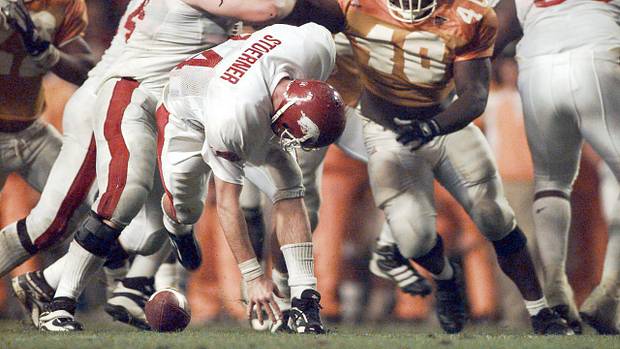 Razorbacks quarterback Clint Stoerner loses the ball on a fumble against Tennessee in 1998 as Brandon Burlsworth blocks