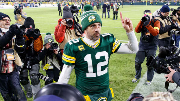 Aaron Rodgers walks off the field after a fourth straight Packers win