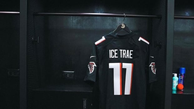Black Falcons jersey with 'ICE TRAE' above No. 11 hangs in Hawks locker room.