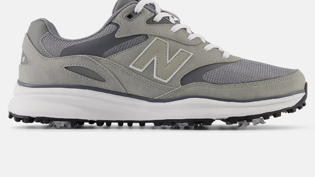 Side view of grey and white New Balance golf shoes.