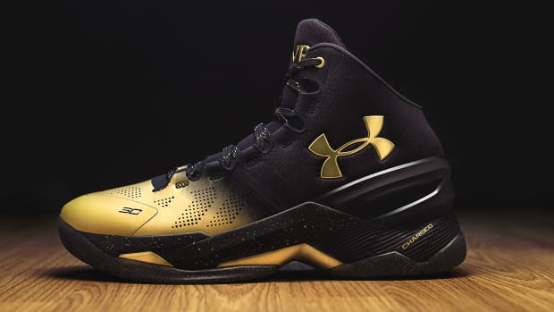 Side view of Stephen Curry's black and gold Under Armour shoe.