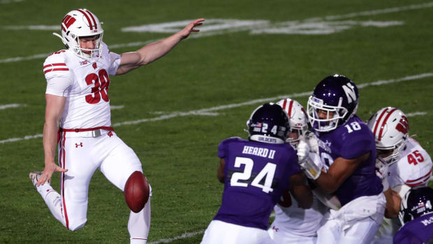 Wisconsin punter Andy Vujnovich (No. 38) punting the football against Northwestern. (Credit: Mark Hoffman via Imagn Content Services, LLC)