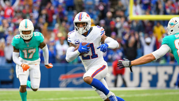 Bills free safety Jordan Poyer (21) returns his interception past Miami Dolphins tight end Mike Gesicki (88) during the second half at Highmark Stadium.