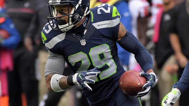 Seattle Seahawks safety Earl Thomas (29) carries the ball on an interception return in the fourth quarter against the Atlanta Falcons during a NFL football game at CenturyLink Field. The Seahawks defeated the Falcons 26-24.