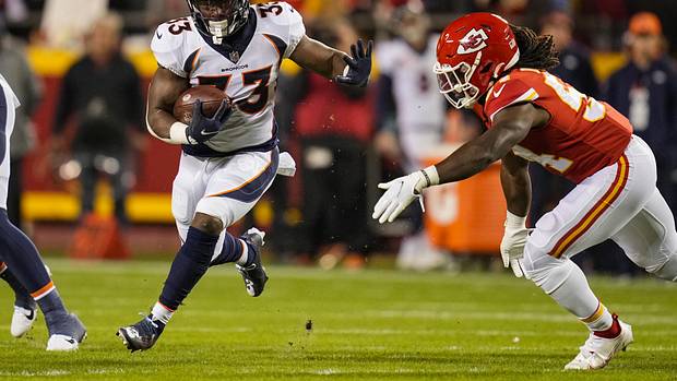 Denver Broncos running back Javonte Williams (33) runs the ball against Kansas City Chiefs linebacker Nick Bolton (54) during the first half at GEHA Field at Arrowhead Stadium.