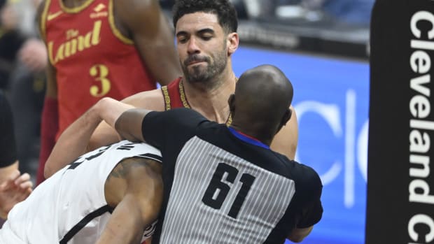 NBA referee Courtney Kirkland (61) breaks up a scuffle between Brooklyn Nets center Nic Claxton (33) and Cleveland Cavaliers forward Georges Niang (20)