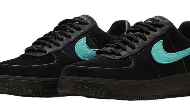 View of black and blue Nike Air Force 1 shoes.