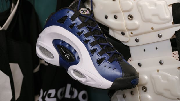 Side view of Emmitt Smith's blue, black, and white Reebok shoes.
