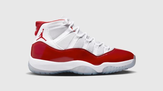 Side view of white and red Air Jordan shoe.