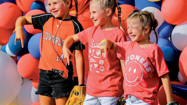 Young fans, Emersyn Edge, Parker Reimer and Emersyn Hensley wait to enter the stadium before the championship series softball game of the Women's College World Series between the University of Oklahoma Sooners (OU) and the Texas Longhorns at USA Softball Hall of Fame Stadium in Oklahoma City, on Wednesday, June 8