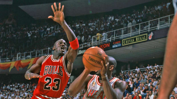 Chicago Bulls guard Michael Jordan attempts to block a shot by Miami Heat guard Vashon Leonard