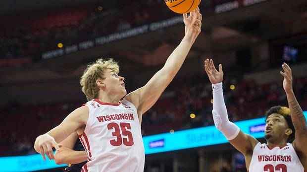 Wisconsin forward Markus Ilver grabbing a rebound against UW-Eau Claire.