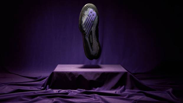The outsole of Coco Gauff's black and purple New Balance tennis shoes.
