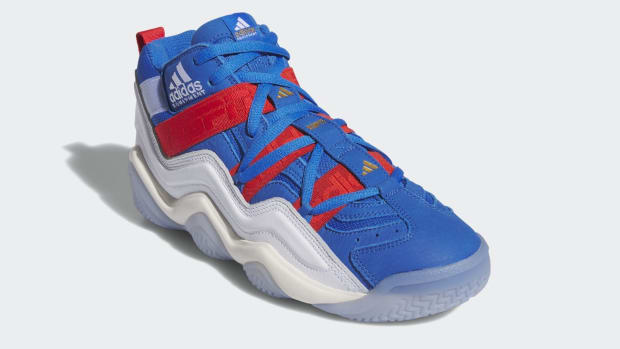 Side view of a blue, white, and red adidas sneaker.