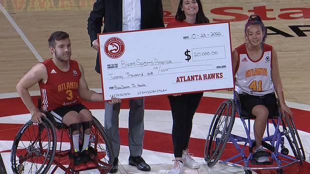 Atlanta Hawks presenting check to Blaze Sports.