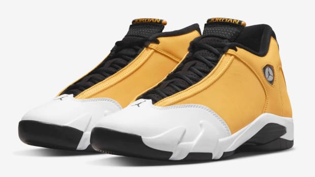View of yellow, white, and black Air Jordan 14 shoes.