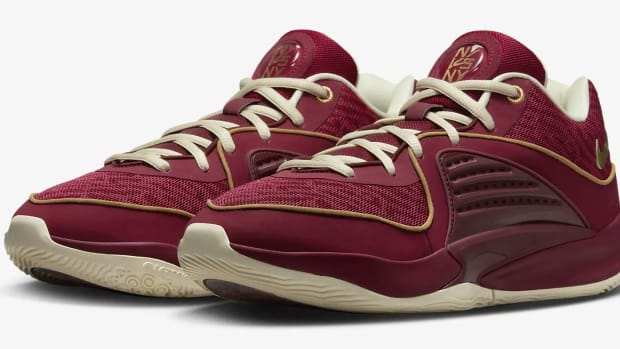 Side view of Kevin Durant's red and gold basketball shoes.