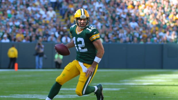 Green Bay Packers quarterback Aaron Rodgers runs with the football.