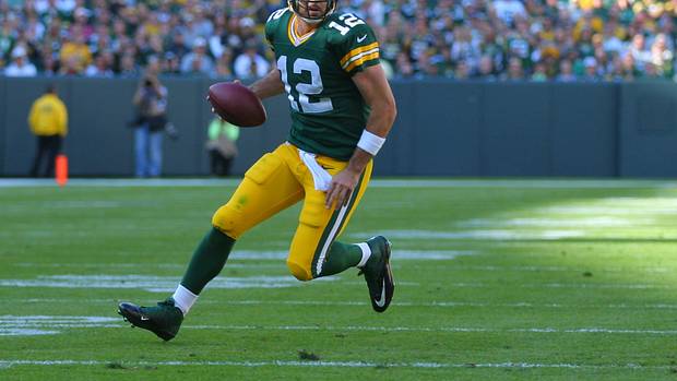 Green Bay Packers quarterback Aaron Rodgers runs with the football.