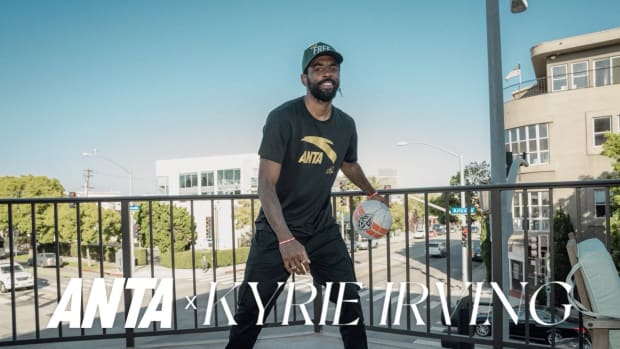 Kyrie Irving dribbles a basketball in ANTA apparel.
