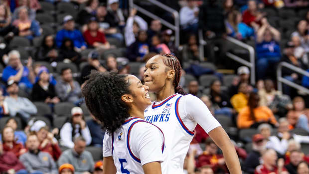 Kansas Jayhawks seniors Taiyanna Jackson and Ryan Cobbins (5) celebrate after defeating the BYU Cougars in the second round of the Big 12 Women's Championship in the T-Mobile Center in Kansas City.
