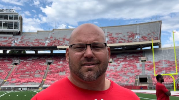 Wisconsin defensive line coach Ross Kolodziej speaking with reports inside Camp Randall Stadium after fall practice (Credit: Matt Belz, All Badgers)