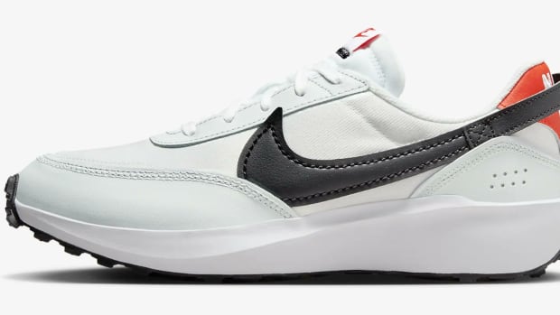 Side view of a white and black Nike running shoe.