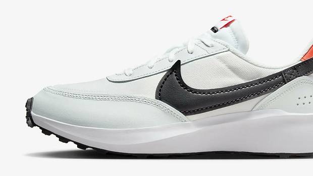 Side view of a white and black Nike running shoe.