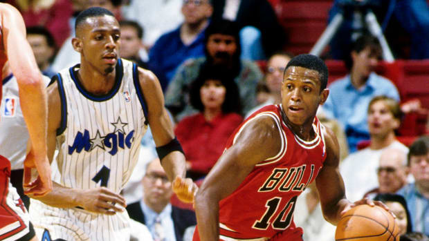 Chicago Bulls guard B.J. Armstrong is chased by Orlando Magic guard Penny Hardaway