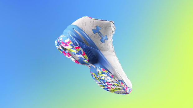 View of white, blue, and pink Under Armour shoe.