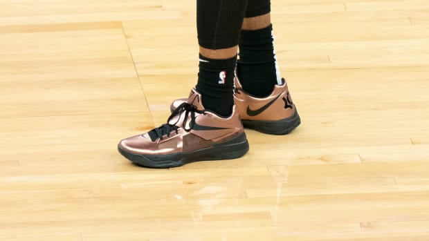 View of copper and black Nike KD shoes.