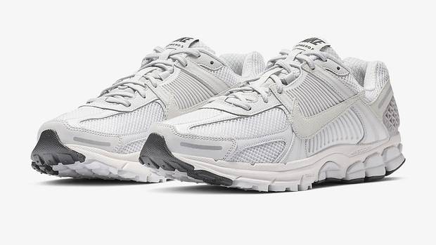 Side view of white and grey Nike sneakers.