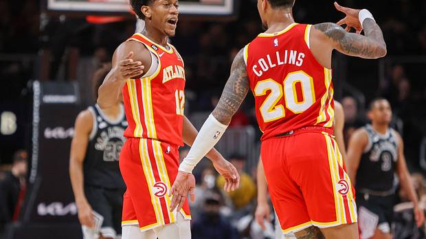 Hawks forwards De'Andre Hunter and John Collins celebrate after a made shot.