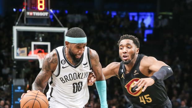 Mar 23, 2023; Brooklyn, New York, USA; Brooklyn Nets forward Royce O'Neale (00) moves the ball against Cleveland Cavaliers guard Donovan Mitchell (45) in the fourth quarter at Barclays Center. Mandatory Credit: Wendell Cruz-USA TODAY Sports