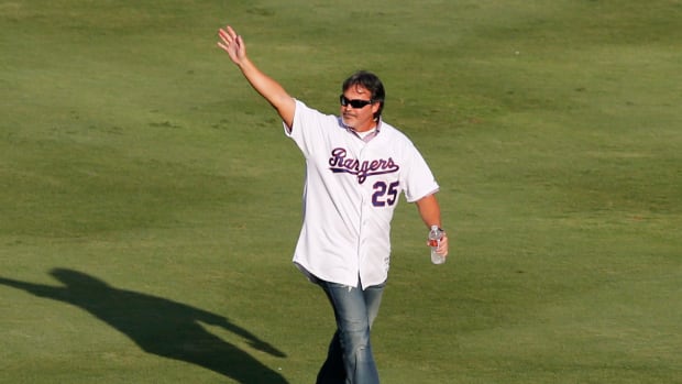 August 11, 2012; Arlington, TX, USA; Texas Rangers former player Rafael Palmeiro waves to fans during introductions of the Rangers 40th anniversary all time team before the game against the Detroit Tigers at Rangers Ballpark in Arlington. Mandatory Credit: Jim Cowsert-USA TODAY Sports