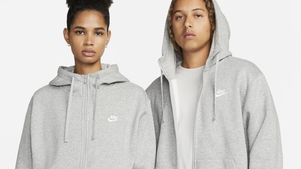 Male and female model wear grey Nike fleece jackets.